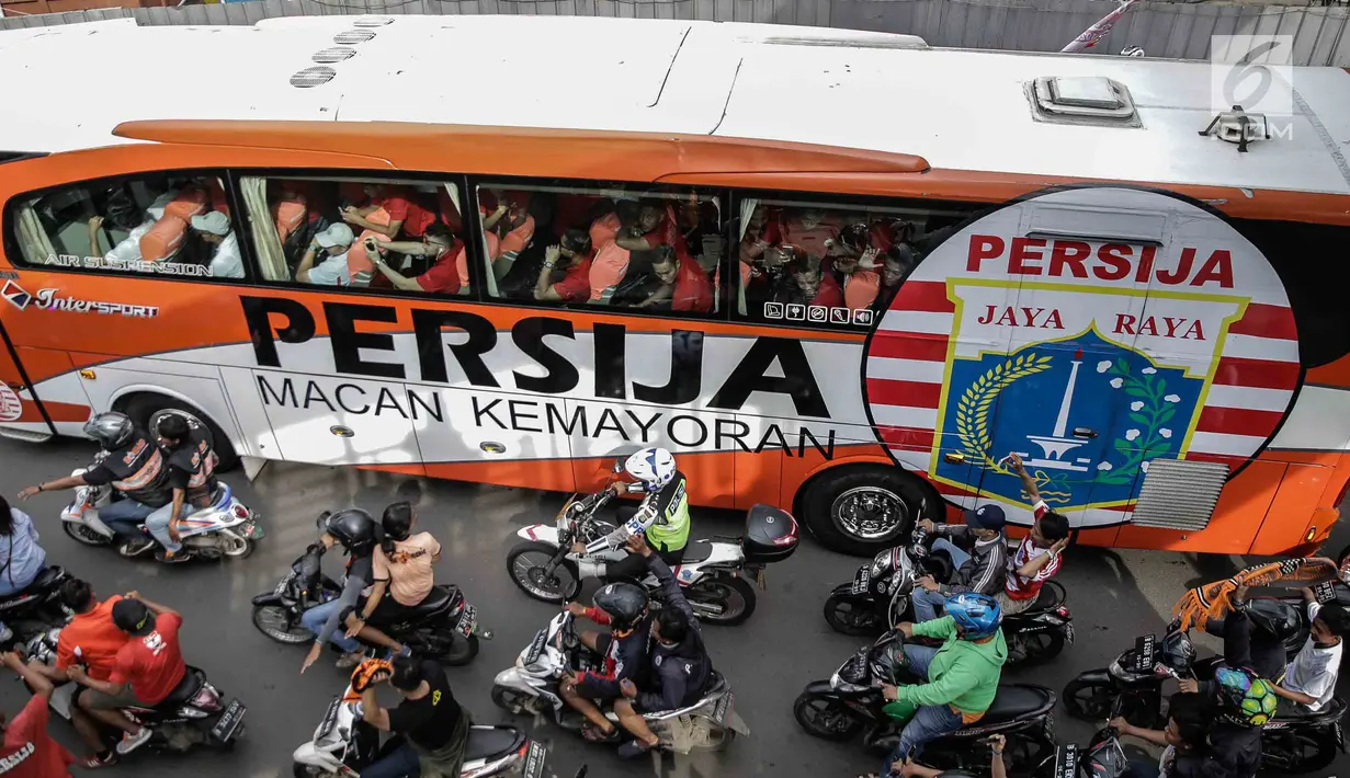 Bus yang membawa pemain Persija, pelatih dan ofisial tim memimpin Pawai Juara Piala Presiden 2018 di kawasan Sudirman, Jakarta, Minggu (18/2). Konvoi arak-arakan dimulai dari Stadion Utama Gelora Bung Karno menuju Balai Kota. (Liputan6.com/Faizal Fanani)