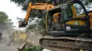 Petugas menggunakan alat berat membongkar bangunan di Jalan Subur Baru, Jakarta, Senin (23/2/2015). Pemprov DKI Jakarta bertujuan melakukan pelebaran jalan dari empat meter menjadi tujuh meter.(Liputan6.com/Faizal Fanani)