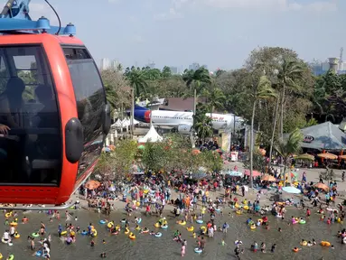 Pengunjung menggunakan wahana Gondola untuk menikmati area wisata Ancol, Jakarta, Sabtu (18/7/2015). Wisata pantai Ancol masih menjadi pilihan favorit warga Jakarta untuk mengisi libur lebaran kedua ini bersama keluarga. (Liputan6.com/JohanTallo)