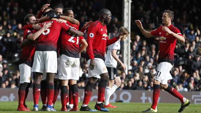 Para pemain Manchester United merayakan gol yang dicetak Paul Pogba ke gawang Fulham pada laga Premier League di Stadion Craven Cottage, London, Sabtu (9/2). Fulham kalah 0-3 dari MU. (AFP/Ian Kington)