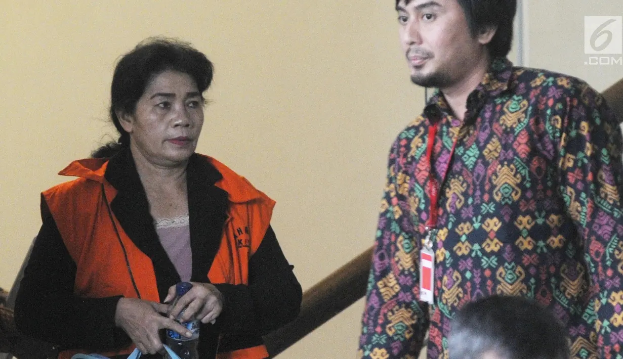 Hakim Adhoc Tipokor PN Medan Merry Purba usai menandatangani berkas P21 tahap 2 di Gedung KPK, Jakarta, Rabu (26/12). Merry mengenakan rompi tahanan dan dikawal petugas KPK. (Merdeka.com/Dwi Narwoko)