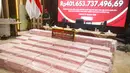 Seorang petugas berjaga di dekat barang bukti uang hasil sitaan terkait kasus dugaan korupsi tata kelola nikel saat konferensi pers di Gedung Bundar, Kejaksaan Agung, Jakarta, Senin, 31 Agustus 2026. (KLY/Arie Basuki).