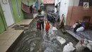 Warga melintasi genangan banjir di kawasan Jatipadang, Jakarta, Rabu (22/11). Jebolnya tanggul Kali Pulo di kawasan tersebut menyebabkan puluhan rumah terendam banjir. (Liputan6.com/Immanuel Antonius)