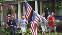 Masyarakat Amerika Serikat (AS) merayakan parade Fourth of July dengan membawa bendera di Westmont, Suburb of Johnstown, Selasa (4/7/2023). (John Rucosky/The Tribune-Democrat via AP)