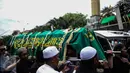 Warga dan kerabat menggotong keranda jenazah korban pembunuhan sadis Pulomas untuk disalatkan di Masjid At Taubah, Pulomas, Kayuputih, Jakarta, Rabu (28/12). Usai disalatkan tiga jenazah akan dimakamkan di TPU Tanah Kusir. (Liputan6.com/Faizal Fanani)