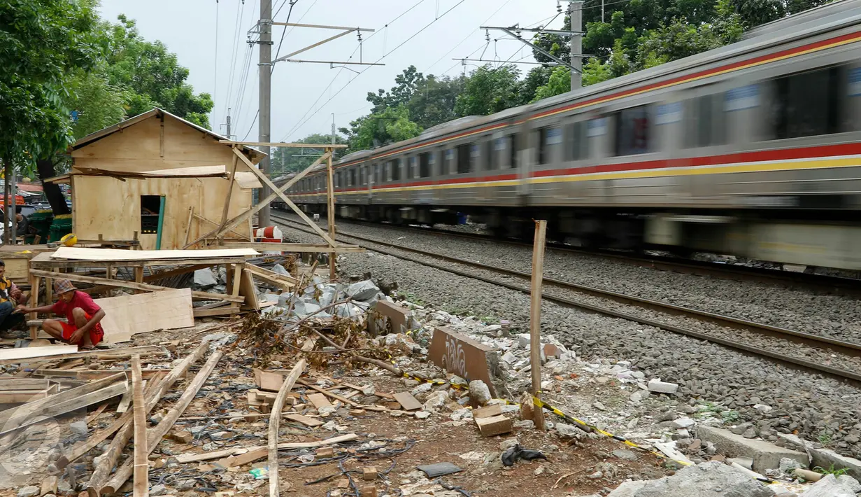 Pekerja menyelesaikan pembuatan pagar pembatas KRL Commuter di sepanjang jalur Tanjung Barat dan Lenteng Agung, Jakarta, Jumat (27/11/2015). Pagar tersebut guna mencegah kecelakaan akibat warga yang menyeberang sembarangan. (Liputan6.com/Yoppy Renato)