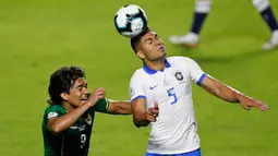 Gelandang Brasil, Casemiro (kanan) berebut bola udara dengan pemain Bolivia, Marcelo Martins Moreno selama pertandingan grup A Piala Copa America 2019 di stadion Morumbi di Sao Paulo, Brasil (14/6/2019). Brasil menang telak 3-0 atas Bolivia. (AP Photo/Nelson Antoine)