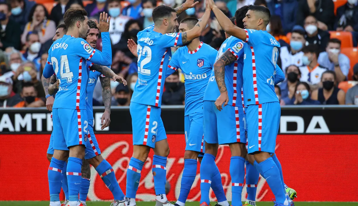 Pemain depan Atletico Madrid, Luis Suarez (kanan) berselebrasi dengan rekan satu timnya setelah mencetak gol ke gawang Valencia pada pertandingan lanjutan La Liga Spanyol di stadion Mestalla di Valencia (8/11/2021). Valencia bermain imbang atas Atletico Madrid 3-3. (AFP/Jose Jordan)
