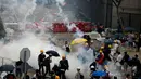 Pengunjuk rasa menghindari gas air mata yang ditembakan oleh polisi anti huru hara di luar gedung Dewan Legislatif, Hong Kong, Rabu (12/6/2019). Polisi Hong Kong telah menggunakan gas air mata ke arah ribuan demonstran yang menentang RUU ekstradisi yang sangat kontroversial. (AP Photo/Vincent Yu)