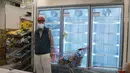 Seorang pria berdiri di deretan lemari es kosong saat warga yang panik menimbun makanan di supermarket Hong Kong, Jumat (4/3/2022). Pemimpin Hong Kong awal pekan ini mengatakan mobilitas orang mungkin dibatasi selama tes covid-19 massal wajib ketika kasus harian mencapai rekor. (AP Photo/Kin Cheung)