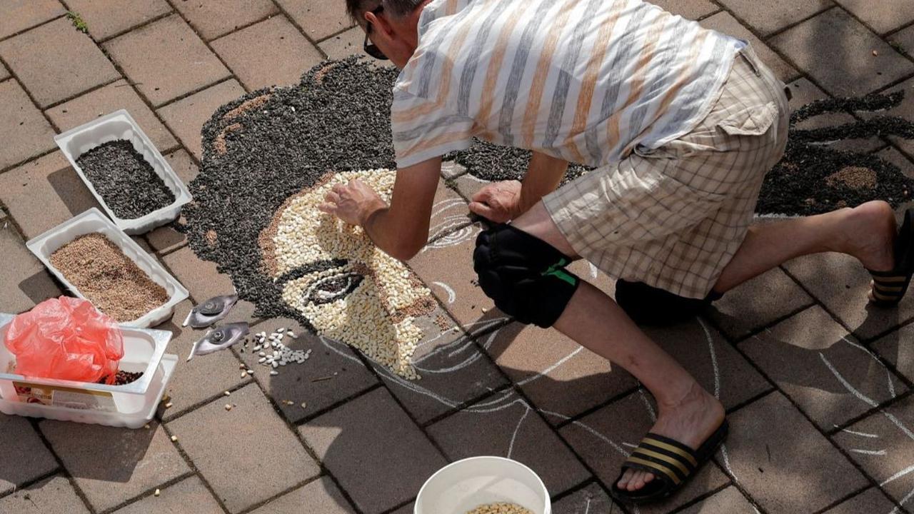 Karya mozaik ini telah menarik perhatian banyak orang, baik warga lokal maupun turis. Banyak yang berhenti sejenak untuk mengagumi detail dan keindahan karya tersebut, serta mengenang kembali sang Raja Pop Michael Jackson. Foto: REUTERS / Valdrin Xhemaj<