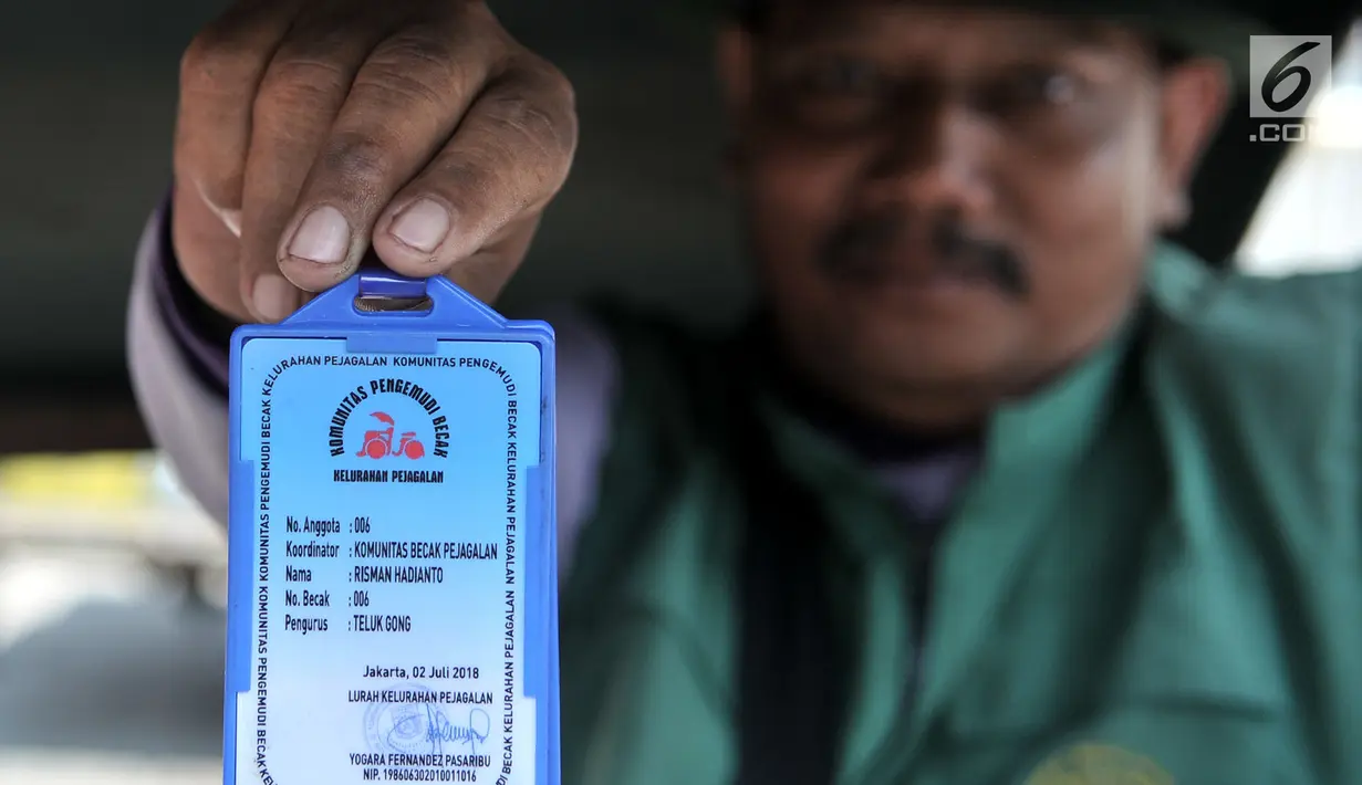 Salah seorang penarik becak menunjukkan kartu anggota yang diberikan oleh Kelurahan Pejagalan, Jakarta, Senin (8/10). Shelter yang berdiri sejak tiga bulan lalu ini mampu menampung sekitar 20 unit becak. (Merdeka.com/Iqbal Nugroho)