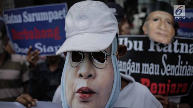 Massa Gerbang (Gerakan Anak Bangsa) mengenakan topeng bergambar  Ratna Sarumpaet  saat unjuk rasa di depan PN Jakarta Selatan, Selasa (19/3). Mereka meminta Ratna Sarumpaet membongkar aktor intelektual dalam penyebaran hoaks. (Liputan6.com/Faizal Fanani)