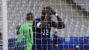 Pemain Prancis, Marcus Thuram, tampak kecewa usai gagal mencetak gol ke gawang Finlandia pada laga uji coba di Stadion Stade de France, Rabu (11/11/2020). Prancis takluk dengan skor 0-2. (AP/Michel Euler)