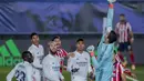 Kiper Real Madrid, Thibaut Courtois menepis bola saat bertanding melawan Atletico Madrid pada pertandingan La Liga Spanyol di stadion Alfredo Di Stefano, Spanyol, Minggu (13/12/2020). Madrid menang atas Atletico 2-0. (AP Photo/Bernat Armangue)