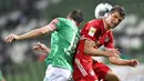 Penyerang Bayern Munchen, Thomas Mueller, duel udara dengan pemain Werder Bremen pada laga Bundesliga di Weserstadion, Bremen, Selasa (16/6/2020). Bayern Munchen menang dengan skor 1-0 atas Werder Bremen. (AP/Martin Meissner)