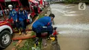 Petugas pemadan kebakaran menyedot air banjir di kawasan Cipinang Melayu, Jakarta, Minggu (21/2/2021). Suku Dinas Pemadam Kebakaran Jakarta Timur mengerahkan 20 mobil pompa untuk menyedot air yang membanjiri RW 04 Kelurahan Cipinang Melayu untuk mengurangi debit air. (Liputan6.com/Faizal Fanani)