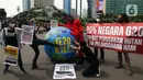 Aktivis iklim melakukan teatrikal dengan membawa bola dunia saat aksi di kawasan Bundaran Hotel Indonesia, Jakarta, Minggu (13/11/2022). Aksi yang digelar berbarengan dengan penyelenggaraan G20 ini meminta pemimpin dunia menemukan solusi bersama atas kondisi ekonomi global. (Liputan6.com/Herman Zakharia)