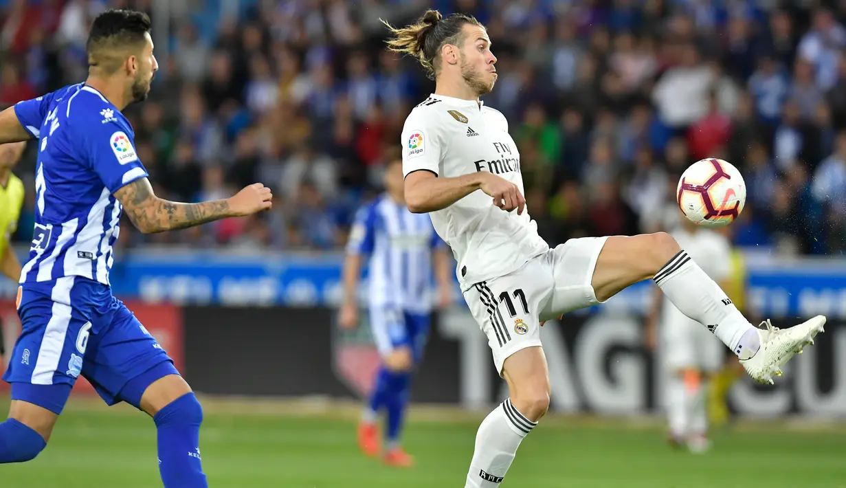 Gelandang Real Madrid, Gareth Bale mengontrol bola dari kawalan pemain Deportivo Alaves Guillermo Maripan saat bertanding di La Liga Spanyol di stadion Mendizorroza, Vitoria (6/10). Madrid takluk 1-0 Deportivo Alaves. (AP Photo/Alvaro Barrientos)