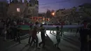 Anak-anak memegang bendera Palestina dalam demonstrasi mendukung keluarga yang kehilangan rumahnya di Beit Lahia, Jalur Gaza, Jumat (4/6/2021). Kendati gencatan senjata telah dilakukan, salah satu masalah yang lebih dalam terkait konflik Israel-Palestina tidak pernah dibahas. (AP Photo/Felipe Dana)