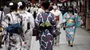 Orang-orang yang mengenakan masker pelindung untuk membantu mencegah penyebaran virus corona berjalan di pusat perbelanjaan di distrik Asakusa di Tokyo, Selasa (29/9/2020). kota Jepang mengonfirmasi lebih dari 200 kasus virus korona pada hari Selasa. (AP Photo/Eugene Hoshiko)