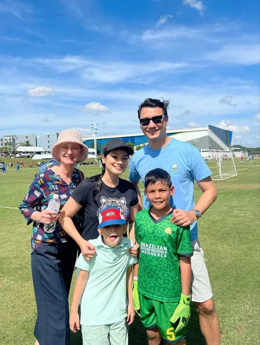 Momen Tikam dan Christian saat mendampingi anaknya mengikuti turnamen bola di Thailand yang diikuti oleh 10 negara. [Foto; Instagram/titi_kamall]