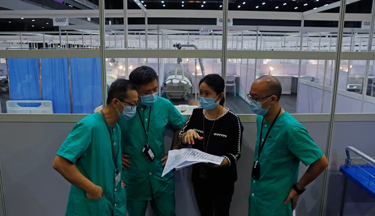 Pekerja medis membuat persiapan di rumah sakit lapangan sementara yang didirikan di Asia World Expo di Hong Kong, Sabtu (1/8/2020). Pusat pameran di dekat Bandara Internasional Hong Kong itu diubah menjadi fasilitas untuk menampung pasien COVID-19 dengan gejala ringan.  (AP Photo/Kin Cheung)