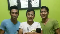 Samsul Arif menggendong anak pertamanya, Syua Thafana Arane, diapit dua pemain Arema Cronus, Benny Wahyudi dan Purwaka Yudi. (Bola.com/Kevin Setiawan)