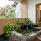 Kolam Ikan Mini dengan Batu Alam di Teras Rumah/ Contoh Kolam Ikan Mini di Teras Rumah Kampung yang Modern (Sumber: gemini.com)