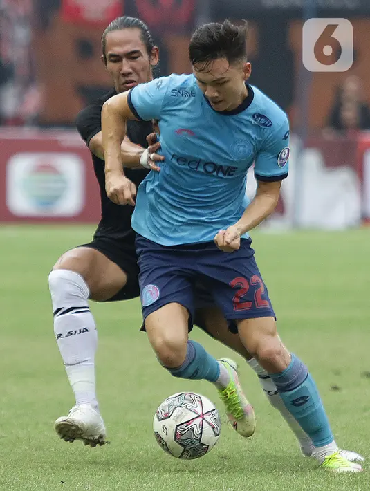Pemain belakang Persija, Ryuji Utomo (kiri) mengadang pemain Sabah FC, Stuart John Wilkin pada laga uji coba internasional di Stadion Patriot Candrabhaga, Kota Bekasi, Minggu (5/6/2022). Persija kalah 1-2 dari Sabah FC. (Liputan6.com/Helmi Fithriansyah)