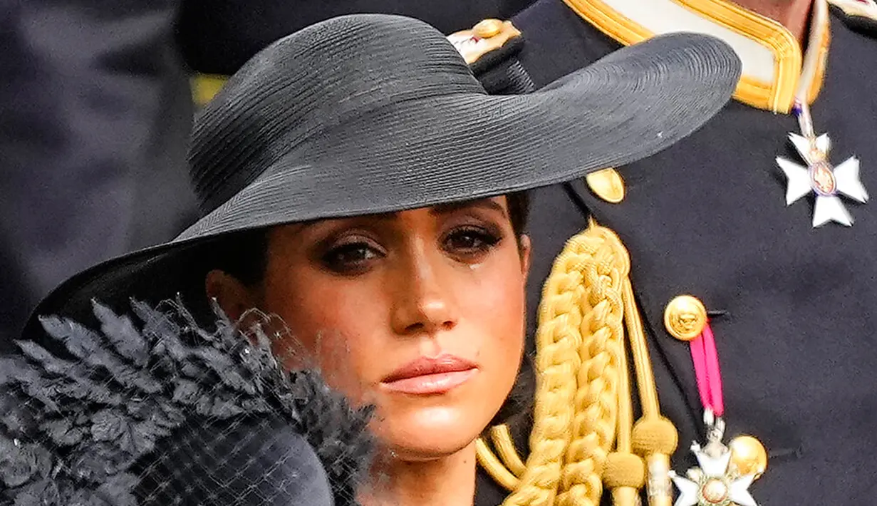 Duchess of Sussex Meghan Markle menyaksikan peti mati Ratu Elizabeth II ditempatkan ke dalam mobil jenazah usai upacara pemakaman kenegaraan di Westminster Abbey, London, Inggris, 19 September 2022. Air mata mengalir dari wajah Meghan Markle saat prosesi pemakaman Ratu Elizabeth II. (AP Photo/Martin Meissner, Pool)