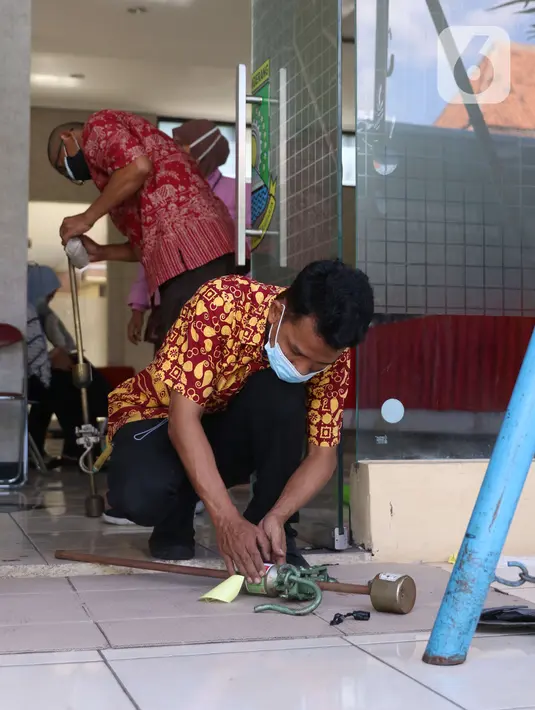 Petugas UPT Disperindagkop UKM Kota Tangerang menempelkan stiker pada alat ukur timbangan saat sidak di Kecamatan Larangan, Kota Tangerang, Banten, Kamis (2/12/2021). Pengecekan dilakukan untuk memastikan alat ukur tersebut tidak ada kesalahan. (Liputan6.com/Angga Yuniar)