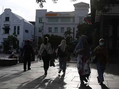 Warga berjalan-jalan di kawasan wisata Kota Tua Jakarta, Rabu (9/12/2020). Libur pelaksanaan Pilkada Serentak 2020 dimanfaatkan sejumlah warga untuk berwisata di kawasan Kota Tua Jakarta. (Liputan6.com/Helmi Fithriansyah)