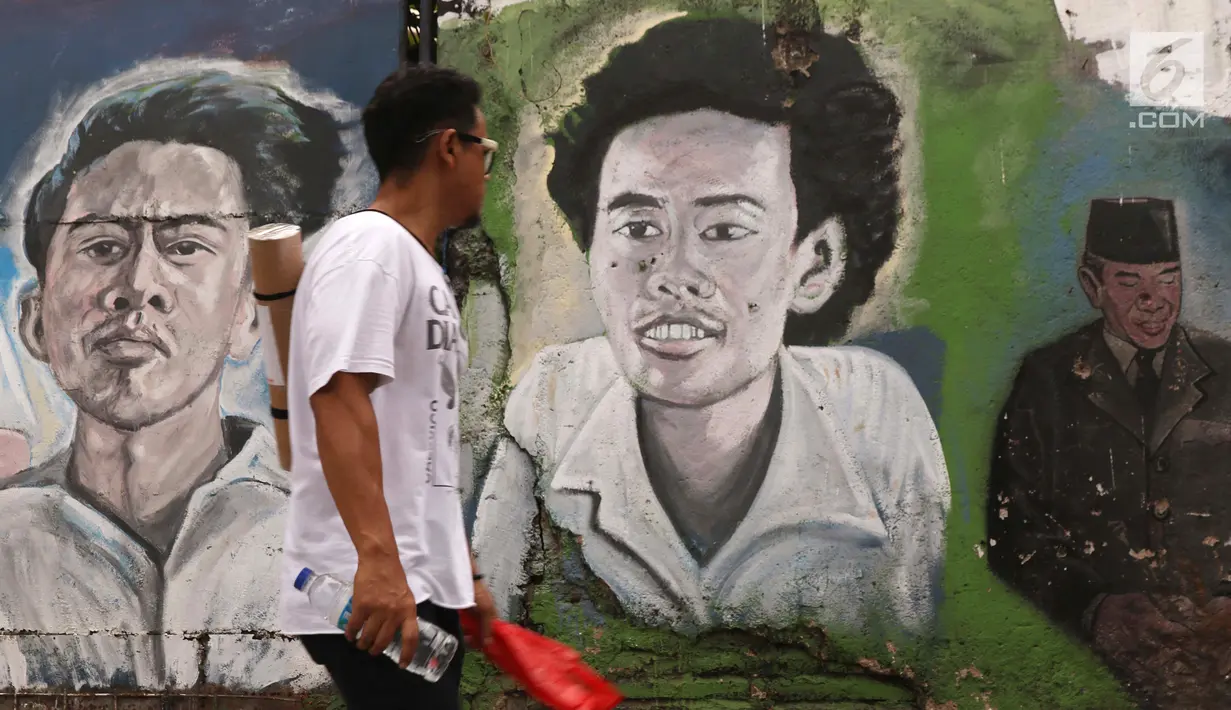 Warga melintasi trotoar jalan Pintu Besar Selatan Kawasan Kota Tua Jakarta, Rabu (23/1). Sejak diluncurkan Oktober tahun lalu, Street Gallery Art diharapkan bisa meningkatkan jumlah wisatawan ke Kota Tua Jakarta. (Liputan6.com/Helmi Fithriansyah)