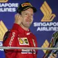 Pembalap Ferrari Sebastian Vettel berselebrasi di podium setelah memenangkan balapan Formula Satu (F1) Grand Prix Singapura di Sirkuit Jalan Marina Bay, Singapura (22/9/2019). Vettel berhasil menjuarai balapan dengan catatan waktu 1 jam:58menit:33.667 detik. (AP Photo/Vincent Thian)