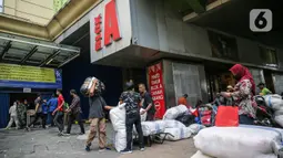 Aktivitas sejumlah orang di depan Pasar Tanah Abang Blok A, Jakarta, Senin (15/6/2020). Setelah hampir tiga bulan ditutup, kawasan Pasar Tanah Abang kembali beroperasi pada Senin (15/6) diikuti dengan penerapan protokol kesehatan pencegahan Covid-19. (Liputan6.com/Faizal Fanani)