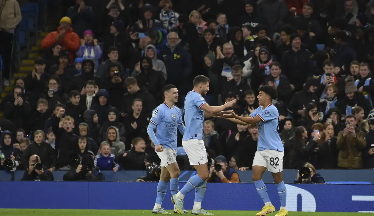 Bek Manchester City, Rico Lewis merayakan dengan rekan setimnya setelah mencetak gol ke gawang Sevilla selama pertandingan lanjutan Grup G Liga Champions di stadion Etihad di Manchester, Inggris, Kamis (3/11/2022). Kemenangan ini memantapkan posisi Man City sebagai juara Grup G dengan mengoleksi 14 poin. (AP Photo/Rui Vieira)