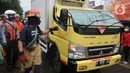 Petugas mengevakuasi truk boks yang rusak parah akibat tertimpa pohon tumbang di Jalan Padjajaran, Kota Tangerang Selatan, Banten, Sabtu (5/3/2022). Pengendara yang terluka karena tertimpa pohon tumbang dibawa ke RSUD Tangerang Selatan. (merdeka.com/Arie Basuki)