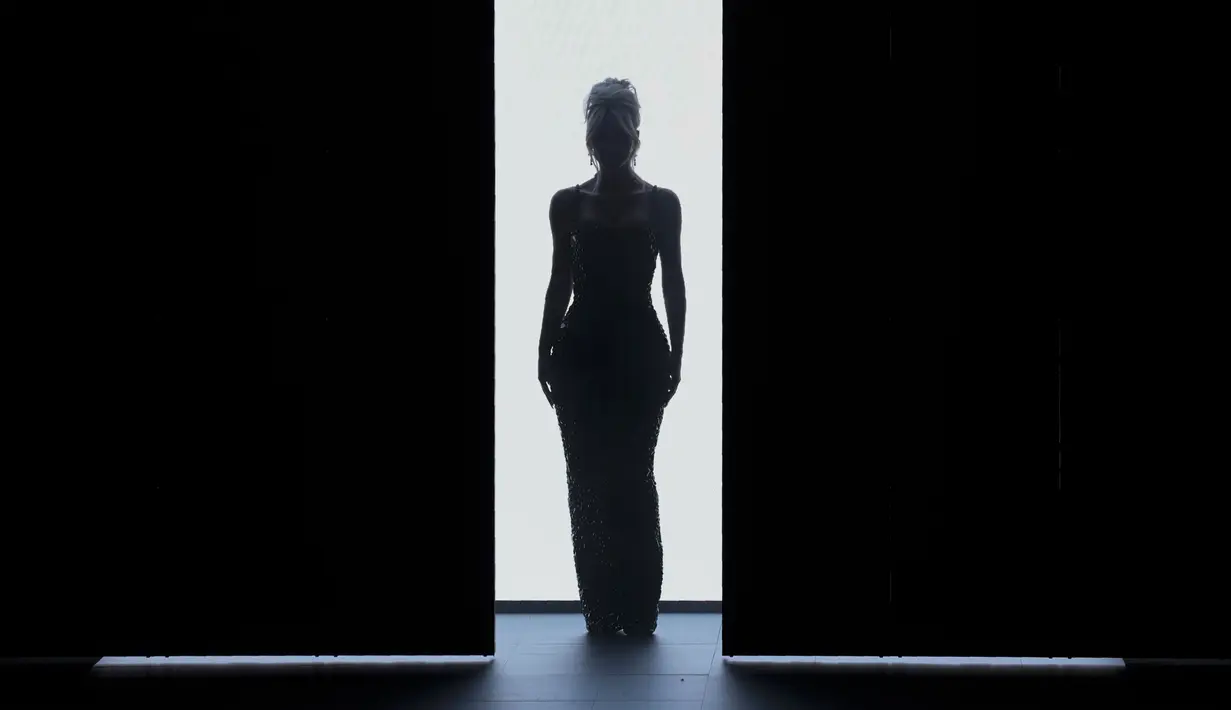 Kim Kardashian mengenakan kreasi koleksi wanita Musim Semi Musim Panas 2023 Dolce & Gabbana  pada event fashion Milan Fashion Week di Milan, Italia, 24 September 2022. Kim Kardashian tampil dalam balutan dress hitam berkilau dengan potongan chic era 60-an.  (AP Photo/Antonio Calanni)