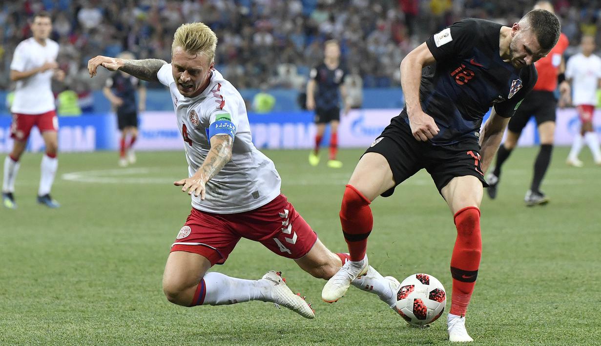 Pemain Denmark, Simon Kjaer (kiri) berebut bola dengan pemain Kroasia, Ante Rebic pada laga 16 besar Piala Dunia 2018 di Nizhny Novgorod Stadium, Rusia, (1/7/2018). Kroasia menang 3-2 lewat adu penalti. (AP/Martin Meissner)