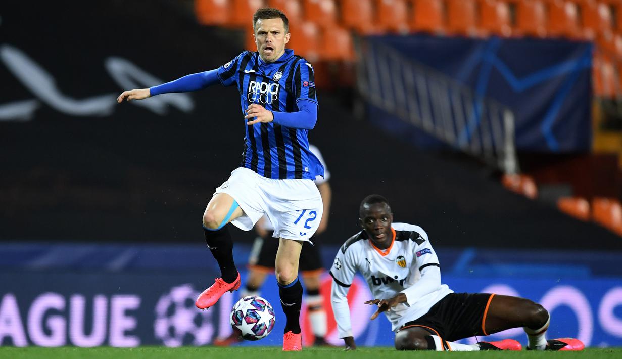 Gelandang Atalanta, Josip Ilicic, berebut bola dengan pemain Valencia pada laga babak 16 besar Liga Champions 2019-2020 di Stadion Mestalla, Valencia, Rabu (11/3). Atalanta menang 4-3 atas Valencia. (AFP/POOL UEFA)