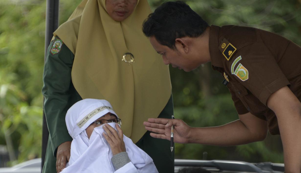 Tjia Nyuk Hwa siap untuk dihukum cambuk di luar Masjid Babussalam, Banda Aceh, Aceh, Indonesia, Selasa (27/2). Hukum cambuk merupakan peraturan daerah yang diberlakukan kepada umat Islam, namun umat non-Muslim bisa memilih, (AFP FOTO/CHAIDEER MAHYUDDIN)