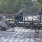 Ilustrasi – pekerja memasang rancang besi dalam pengecoran jalan. (Liputan6.com/Muhamad Ridlo)