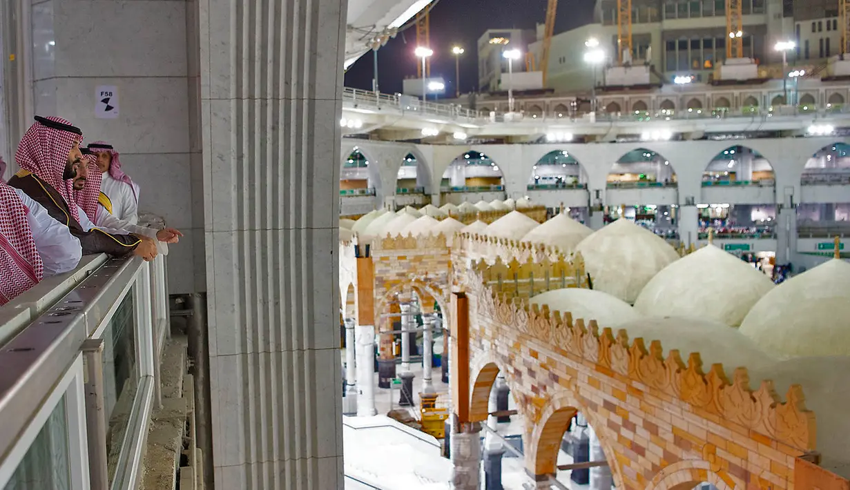 Putra Mahkota Arab Saudi Mohammed bin Salman memantau jemaah yang beribadah saat meninjau Masjidil Haram di Mekah, Arab Saudi, Selasa (12/2). Mohammed memberi pengarahan tentang proyek perluasan Masjidil Haram. (BANDAR AL-JALOUD/SAUDI ROYAL PALACE/AFP)