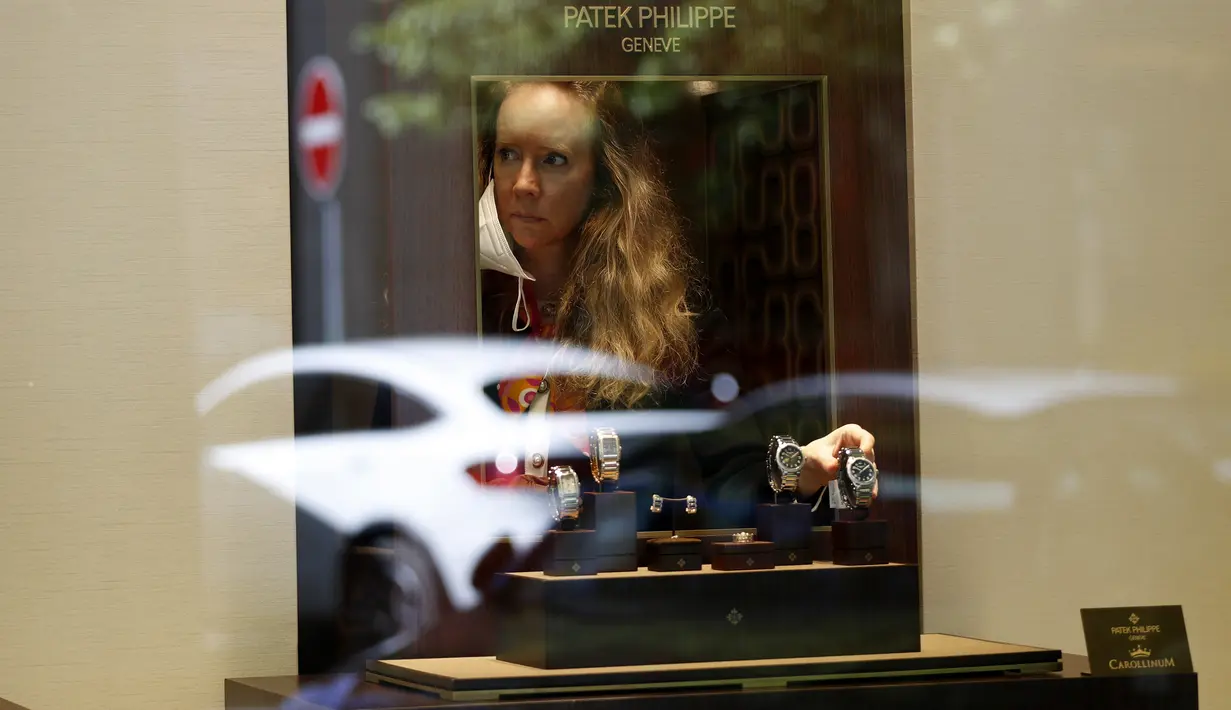 Seorang wanita menyesuaikan jam tangan di sebuah toko di Praha, Republik Ceko, Senin (10/5/2021). Ceko secara besar-besaran melonggarkan pembatasan COVID-19 karena negara paling terpukul pandemi di Eropa itu memberikan penghormatan kepada hampir 30.000 korban meninggal. (AP Photo/Petr David Josek)