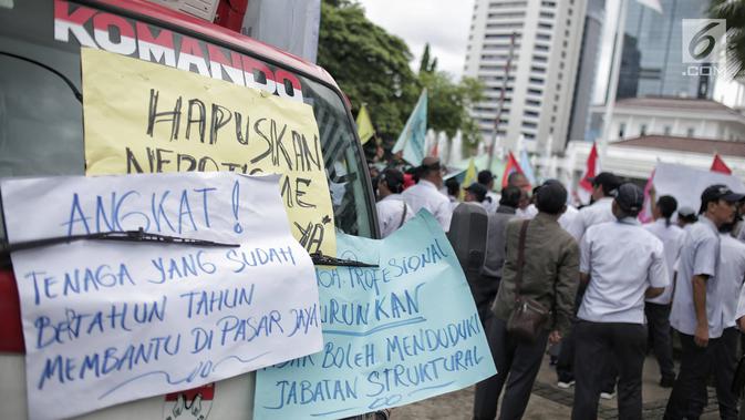 Sejumlah poster dalam unjuk rasa yang digelar oleh massa dari Serikat Pegawai PD Pasar Jaya di depan Balai Kota DKI Jakarta, Rabu (31/1). Mereka menolak tenaga profesional PKWT & PKWTT yang Kolusi, korupsi, Nepotisme (KKN).  (Liputan6.com/Faizal Fanani)