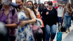Penumpang berjalan di sepanjang peron di stasiun kereta utama di Frankfurt, Jerman, Jumat (14/8/2020). Mengenakan masker untuk melindungi diri dari corona Covid-19 adalah kewajiban di transportasi umum di Jerman. (AP Photo/Michael Probst)