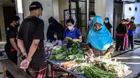 Warga antre mengambil sayuran gratis saat bazar di Masjid Ar Ruhama, Jati Padang, Minggu, (25/4/2021). Bazar sayuran gratis tersebut sebagai bentuk aksi solidaritas Masjid Ar Ruhama dalam membantu warga lainnya yang terdampak pandemi COVID-19 saat Ramadhan. (Liputan6.com/Faizal Fanani)