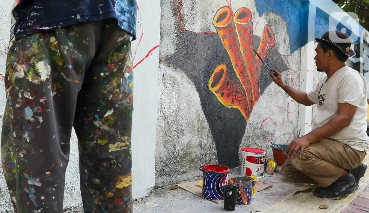 Seniman menyelesaikan pembuatan mural bertema biota laut pada dinding di kawasan Cideng, Jakarta, Rabu (29/11/2023). Mural dibuat guna memperindah sekaligus penataan kawasan Kelurahan Cideng, Jakarta Pusat. (Liputan6.com/Herman Zakharia)