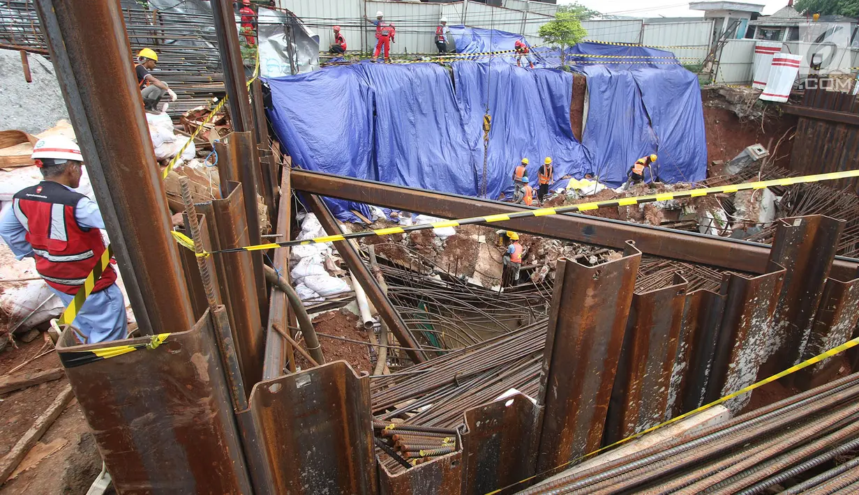 Pekerja konstruksi merapikan lereng galian pondasi pembangunan tiang pancang proyek LRT dan flyover Pancoran yang longsor di Jakarta, Jumat (13/10). (Liputan6.com/Immanuel Antonius)